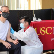 Los Angeles Mayor Eric Garcetti receives a flu shot from Richard Dang, assistant professor at the USC School of Pharmacy, on Sept. 22, 2020. (Photo by Isaac Mora)